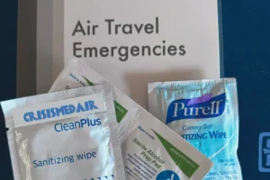 An array of alcohol prep pads with a Crisis Medicine Air Travel Emergencies card as the background