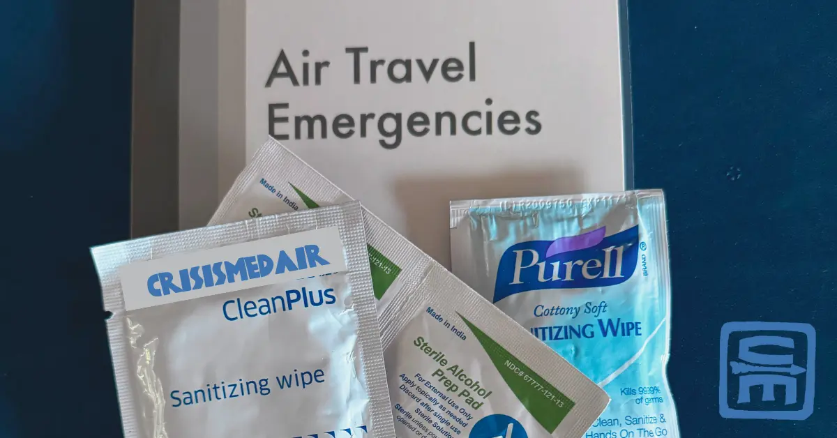 An array of alcohol prep pads with a Crisis Medicine Air Travel Emergencies card as the background